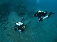 Technical divers performing skills at 42m on the seabed next to Zenobia Shipwreck in Larnaca Cyprus