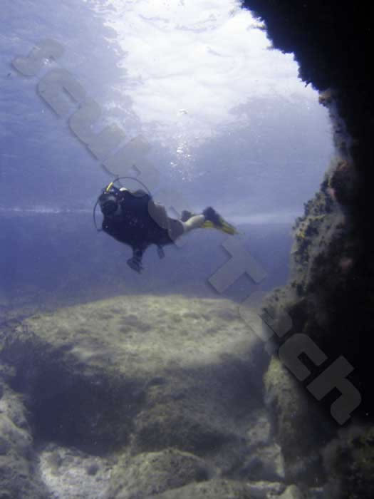 diver is pictures just outside one of the entrances to a cave in Cyprus