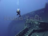 technical diver at the bow of zenobia gives some scale to this massive wreck
