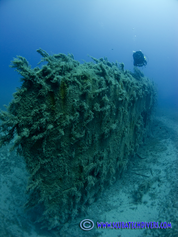 scuba diver diving on the wreck of the cricket